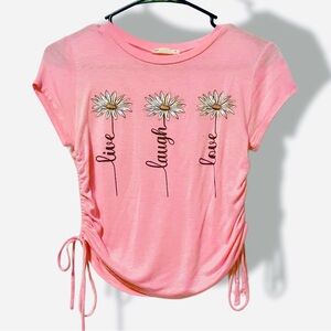 Pink “Live, Laugh, Love" graphic T with daisy flowers and drawing sides. size S